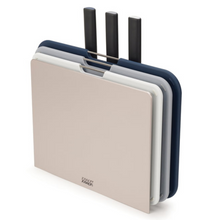 Load image into Gallery viewer, Silver, Slimline casing which houses a selection of 3 colour coded boards and 3 kitchen knives. All in varying tones of grey.