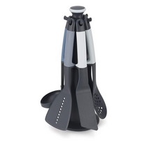 Load image into Gallery viewer, A dark grey carousel style stand which holds 6 elevate utensils. The Utensils all have coloured handles of different shades of blue and grey.