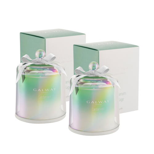 A pair of filled glass candles with glass bell jar lid. They come in their own gift box. They are a green ombre with an iridescent finish. 