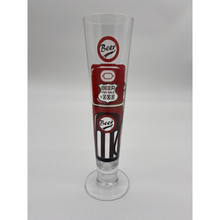 Load image into Gallery viewer, Tall slim Pilsner style beer glass wih red and black beer pump in the style of an american fuel pump.
