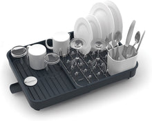 Load image into Gallery viewer, A dark grey, rectangular dish drainer with chrome ronged grid which can be used separately, to hold plates, bowls, mugs and glasses. A white cutlery holder, a draining spot and a removable plug.
