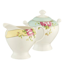 Load image into Gallery viewer, White Background. Aynsley Archive Rose Cream Jug and Covered Sugar Bowl. The Cream jug is white fine china with a yellow band around the rim. Decorated with delicate circles, pink roses and green leaves. The sugar bowl is white fine china with a blue band around with lid with delicate circles on the band. And a blue band around the rim of the bowl. There are pink roses and green leaves motifs on either side of the bowl, on the blue band. The bowl has 2 handles.
