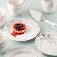 Load image into Gallery viewer, This is a lifestyle image of the Charbagh collection by Aynsley. There are mugs, side plates, a cake slice and pastry forks, all sitting on a glass worktop. There is a berry cheesecake on the center plate.
