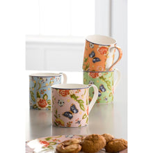 Load image into Gallery viewer, A lifestyle image of 4 different coloured mugs. 1 pink. 1 blue. 1 coral. 1 green. All with a white interior and handle. All sporting a rose, daisy, leaves and blue butterflies pattern. There is a coordinating plate in the foreground with small biscuits on it.
