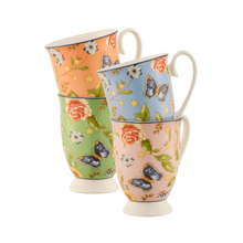 Load image into Gallery viewer, White background. Aynsley Cottage Garden Set of 4 Footed Mugs. Fine White Porcelain mugs. 1 Blue, 1 Pink, 1 Coral and 1 Green. They all have the rose, daisy, leaves and blue butterfly pattern all over these background colours.
