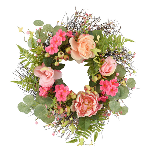 A hand crafted pink floral door wreath with peonies and pale pink roses. Plenty of green leaves and ferns.