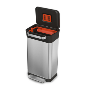 A rectangular, stainless steel bin with black trim and stainless steel handle and foot pedal. Inside there is an orange filter cover and orange trash compactor.