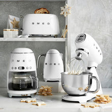 Load image into Gallery viewer, Collection of Smeg 50s Retro items in White. Toaster, Drip Coffee Machine, Kettle and Stand Mixer. Surrounded by Star and Snowflake biscuits.
