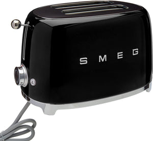 White Background. Black Smeg 50's Style Retro 2 Slice Toaster with silver embossed letters S M E and G across the front. A silver press down lever, turning temperature knob, defrost, reheat and stop buttons. The toaster is chrome at the top and bottom.