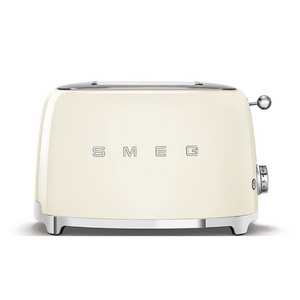 A front view. White Background. Cream Smeg Retro 50's style 2 slicer toaster. It has a cream body, Chrome top and base with chrome embossed letters S M E and G across the front. The push down lever, browning knob, defrost, reheat and stop buttons are all chrome.