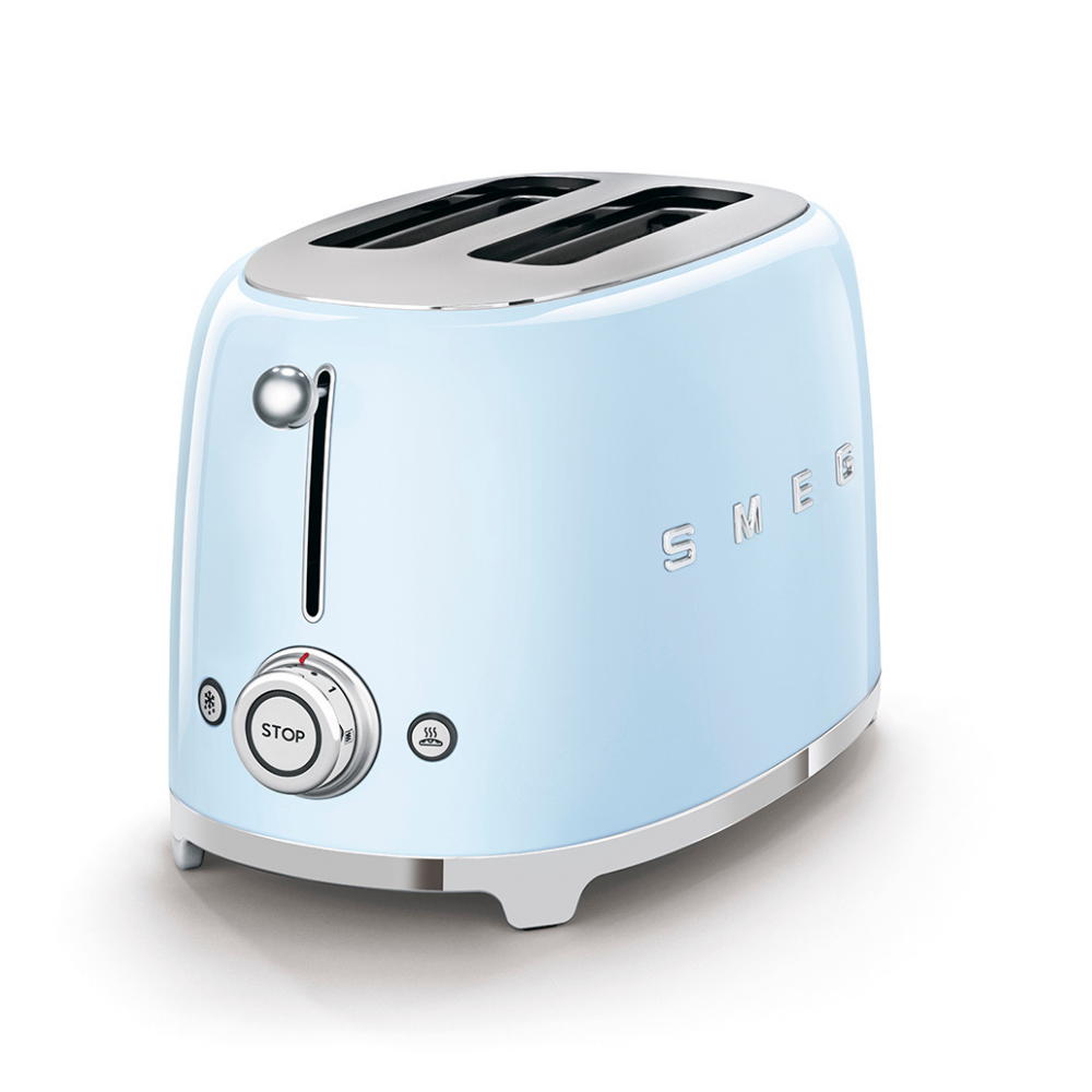White Background. Smeg 2 slice 50's retro toaster. The body is Pastel blue and it is chrome at the top and bottom. There are chrome S M E and G letters embossed on the front and back. The push down leaver, browning knob, defrost, reheat and stop buttons are all chrome.