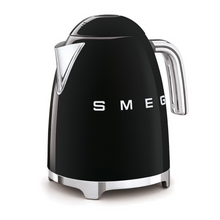 Load image into Gallery viewer, White Background. Smeg 50s Retro 1.7L Kettle. The body of the kettle is Black. There are chrome letters S, M, E and G embossed on each side. The lid is push button release. The spout, Handle, on/off lever and base are chrome. There is a water level window in line with the handle.
