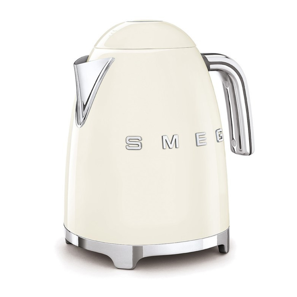 White Background. Smeg 50s Retro 1.7L Kettle. The body of the kettle is Cream. There are chrome letters S, M, E and G embossed on each side. The lid is push button release. The spout, Handle, on/off lever and base are chrome. There is a water level window in line with the handle.