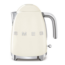 Load image into Gallery viewer, Front View. White Background. Smeg 50s Retro 1.7L Kettle. The body of the kettle is Cream. There are chrome letters S, M, E and G embossed on each side. The lid is push button release. The spout, Handle, on/off lever and base are chrome. There is a water level window in line with the handle.
