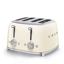 Load image into Gallery viewer, White Background. Smeg 50&#39;s Retro Cream 4 Slice Toaster. The body of the toaster is Cream with chrome letters S, M, E and G embossed on either side. The top, base, levers, knobs and buttons are all chrome. There are two push down levers, two browning knobs, two defrost, two reheat and two stop buttons. One for each set of 2 slots.
