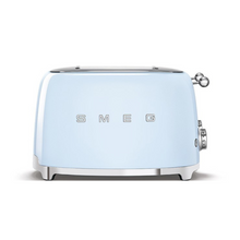 Load image into Gallery viewer, Front View. White Background. Smeg 50&#39;s Retro Pastel Blue 4 Slice Toaster. The body of the toaster is Pastel Blue with chrome letters S, M, E and G embossed on either side. The top, base, levers, knobs and buttons are all chrome. There are two push down levers, two browning knobs, two defrost, two reheat and two stop buttons. One for each set of 2 slots.

