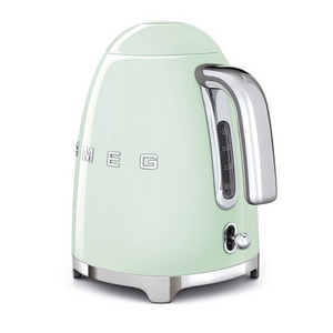 Rear Side View. White Background. Smeg 50s Retro 1.7L Kettle. The body of the kettle is Pastel Green. There are chrome letters S, M, E and G embossed on each side. The lid is push button release. The spout, Handle, on/off lever and base are chrome. There is a water level window in line with the handle.
