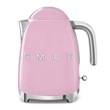 Load image into Gallery viewer, Front View. White Background. Smeg 50s Retro 1.7L Kettle. The body of the kettle is Pink. There are chrome letters S, M, E and G embossed on each side. The lid is push button release. The spout, Handle, on/off lever and base are chrome. There is a water level window in line with the handle.
