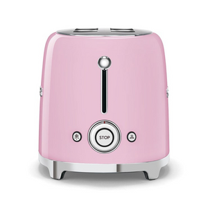 Side view. White Background. Smeg Pink 50s Retro 2 Slice Toaster. The body of the toaster is pink with chrome letters S, M, E and G embossed on both sides. The top and base are chrome. The push down lever, defrost, reheat, stop buttons and browning knob are all chrome.