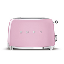 Load image into Gallery viewer, Front view. White Background. Smeg Pink 50s Retro 2 Slice Toaster. The body of the toaster is pink with chrome letters S, M, E and G embossed on both sides. The top and base are chrome. The push down lever, defrost, reheat, stop buttons and browning knob are all chrome.
