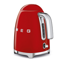 Load image into Gallery viewer, Rear Side View.White Background. Smeg 50s Retro 1.7L Kettle. The body of the kettle is Red. There are chrome letters S, M, E and G embossed on each side. The lid is push button release. The spout, Handle, on/off lever and base are chrome. There is a water level window in line with the handle.
