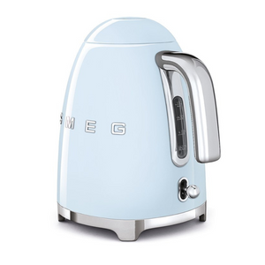 Rear Side View. White Background. Smeg 50s Retro 1.7L Kettle. The body of the kettle is Pastel Blue. There are chrome letters S, M, E and G embossed on each side. The lid is push button release. The spout, Handle, on/off lever and base are chrome. There is a water level window in line with the handle.