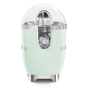 White background. The Smeg 50s Retro Citrus juicer. The body is pastel green. The reamer, spout and base are chrome. There is a clear dome over the top of the reamer. There are chrome letters S, M, E and G embossed on either side.